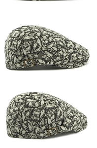 Detail of vintage duckbill cap with black and white abstract print and bronze metal buckle