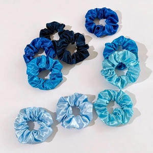 9-piece set of satin silk scrunchies in gradient blue shades on white background
