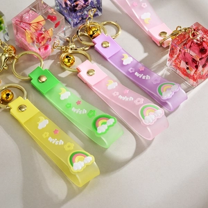 Detailed macro view of four pastel floral resin cube keychains with wish silicone wristbands