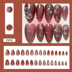 Dark red press-on nails with 3D liquid metal, pearls and star patterns in long coffin shape