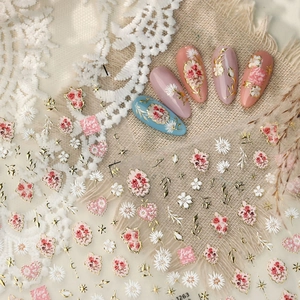 French floral nail stickers with pink blooms, white daisies and golden lines for manicure