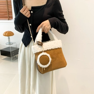 Brown suede bucket bag with white faux fur trim and adjustable metal chain strap