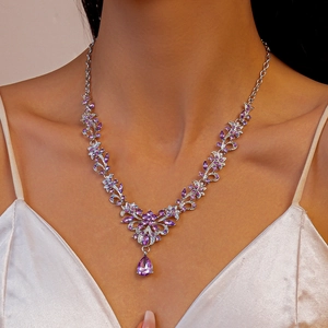 Detailed view of luxury silver floral necklace with purple marquise stones and drop pendant