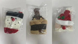 Detailed view of knitted Christmas bottle covers featuring Santa, Snowman and Reindeer