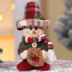 Detail of Christmas snowman ornament with knitted hat and scarf in warm festive setting