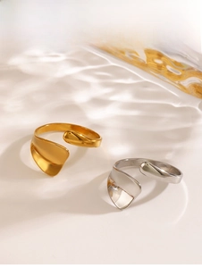 Detail of minimalist gold and silver open rings with fluid irregular curved design