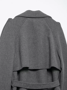 Close-up of deep gray wool coat back showing storm flap and belt loops detail