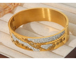Macro shot of 18K gold plated hollow floral bangle with white sparkling diamonds