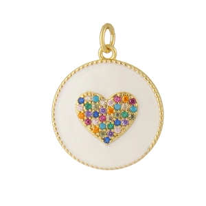 Macro shot of gold-plated circular pendant with white enamel and colorful zircon heart