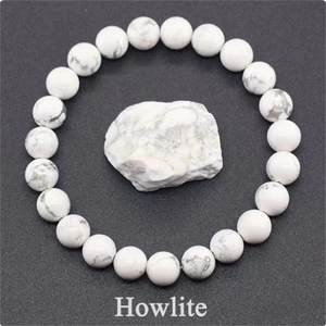 Macro detail of natural white howlite beaded stretch bracelet with grey marble veins