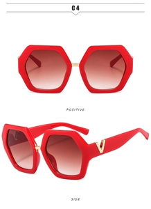 Macro detail of red hexagonal sunglasses with gradient lenses and gold V-shaped metal trim
