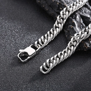 Macro shot of silver stainless steel Cuban link chain with secure lobster clasp detail