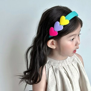 Sweet turquoise sponge headband with colorful heart charms on a girl for kids hair styling