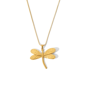 Macro detail of golden dragonfly pendant with textured wings on a sleek snake chain