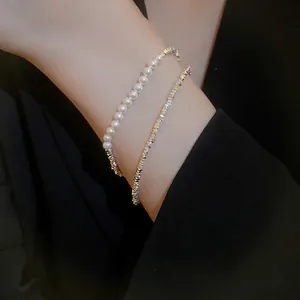 Elegant double-layer bracelet with white pearls and faceted silver beads on wrist