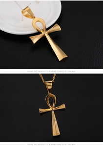 Polished golden stainless steel Ankh cross pendant showing details and texture