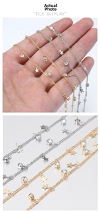 Close-up of gold and silver star chains with sparkling cubic zirconia charms