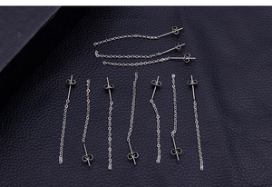 Detail of silver long chain earrings with tassels and butterfly backings on leather