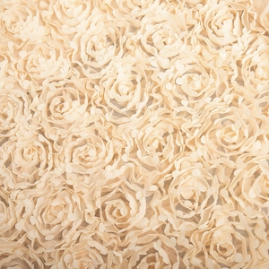 Detailed macro view of 3D champagne rose applique texture on sheer mesh evening skirt