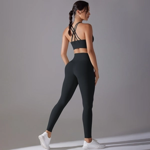 Detail of cross-back strappy sports bra and high-waisted leggings in black