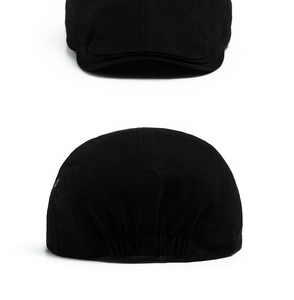 Rear view of black cotton flat cap showing elastic band detail for adjustable fit