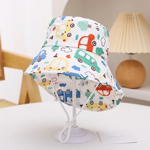 Kids white sun hat with colorful cartoon car prints and adjustable chin strap on a stand