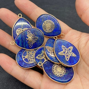 Close-up of lapis lazuli pendants with gold Tree of Life and animal patterns