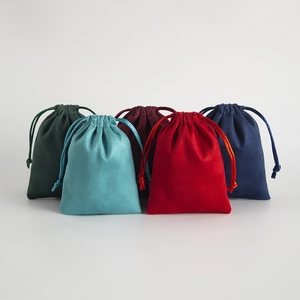 Macro detail of multicolored suede drawstring jewelry pouches in soft fabric
