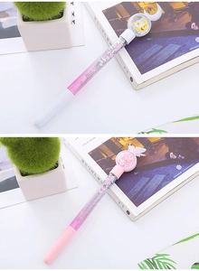 Detail showing pink gradient pens with flowing glitter sequins and cute cartoon toppers