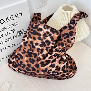 Classic leopard print canvas tote bag displayed in a stylish minimalist interior setting