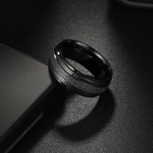 Sleek black stainless steel wedding ring with frosted center band and polished edges
