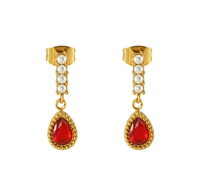 Detailed close-up of gold earrings with four small pearls and a red teardrop gemstone