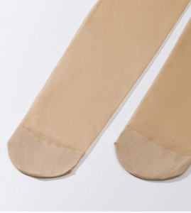 Close-up of sheer skin-tone tights featuring reinforced toes and fine mesh texture