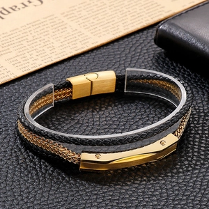 Close-up of multi-layer black leather and gold chain bracelet with magnetic clasp