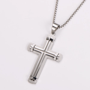 Detail of two-tone stainless steel cross pendant featuring matte and polished finishes