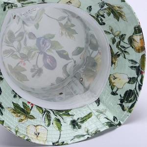 Close-up of fruit pattern bucket hat showing breathable mesh lining and washing label
