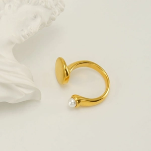 Adjustable gold plated stainless steel ring with white pearl on minimalist stone display