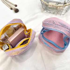 Close-up of mesh makeup bags in purple and pink with double-layer storage design