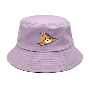 Detail view of lavender bucket hat featuring creative zipper bear graphic and fine stitching