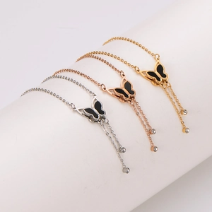 3D butterfly pendant necklace in silver, gold, and rose gold with black inlay and tassels