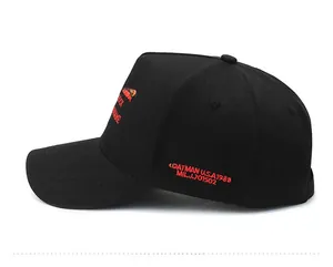 Detailed side view of black baseball cap featuring red embroidered letters and cotton texture