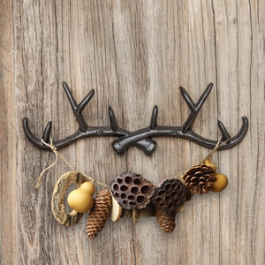 Vintage cast iron antler wall hook for coat and hat storage in rustic bronze finish