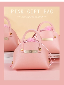Close-up of pink PU leather shell-shaped candy bag with Sweet Love metal tag for weddings