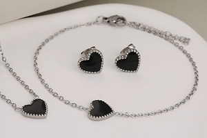 Three-piece stainless steel jewelry set with black heart pendants and silver beaded edges