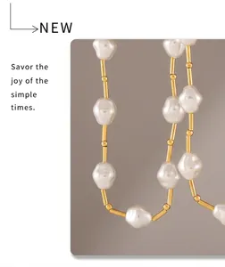 Detail of 18k gold plated titanium necklace featuring baroque pearls and sleek metal chain