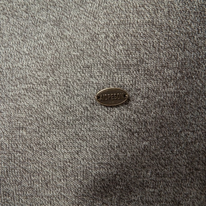 Men's premium grey knit cardigan featuring a high-quality fabric texture and metal brand tag
