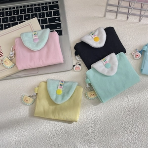 Flat lay of colorful multi-functional card holders with plush flaps and cute animal charms