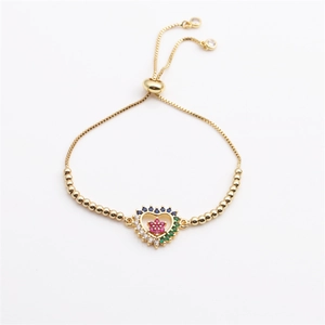 Adjustable gold heart bracelet with colorful cubic zirconia stones on white background