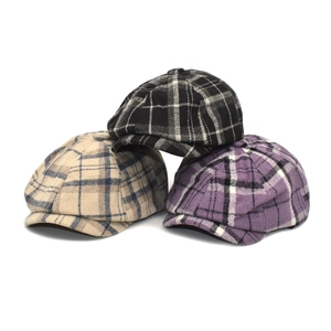Three wool blend plaid newsboy caps in black, beige, and purple on a white background