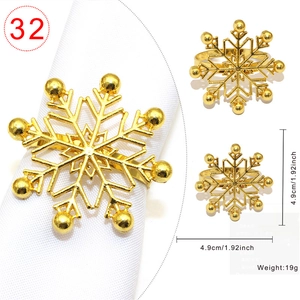 Detail view of golden snowflake metal napkin ring with size specs and weight